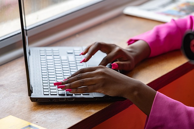 Image of a person working on a laptop